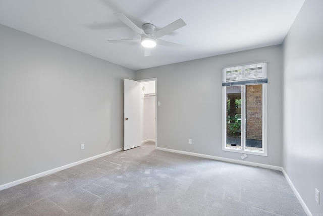 spare room featuring ceiling fan and light colored carpet