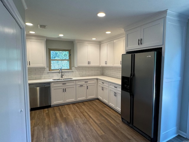 kitchen with appliances with stainless steel finishes, white cabinets, and dark hardwood / wood-style floors