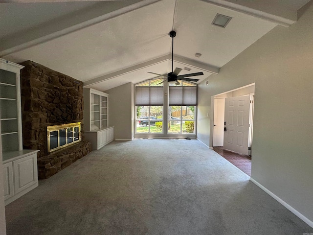 unfurnished living room featuring carpet floors, beamed ceiling, a fireplace, high vaulted ceiling, and ceiling fan