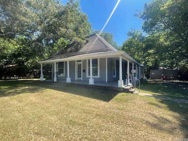 view of front of home featuring a front yard, covered porch, and roof with shingles