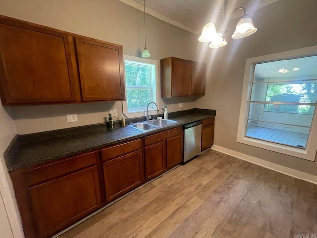 kitchen with sink, decorative light fixtures, stainless steel dishwasher, and light hardwood / wood-style flooring