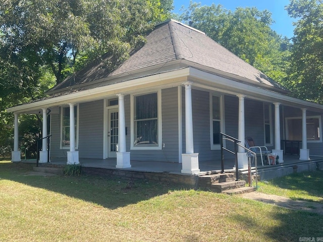 country-style home with a front yard and a porch