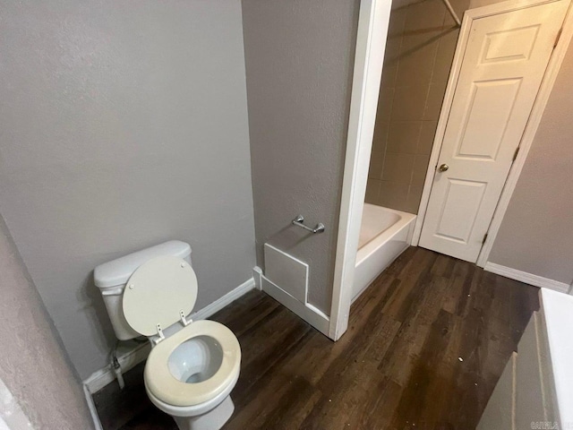 bathroom featuring toilet, wood-type flooring, and shower / bath combination