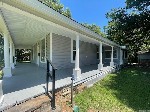 view of home's exterior featuring covered porch, an attached carport, and a lawn