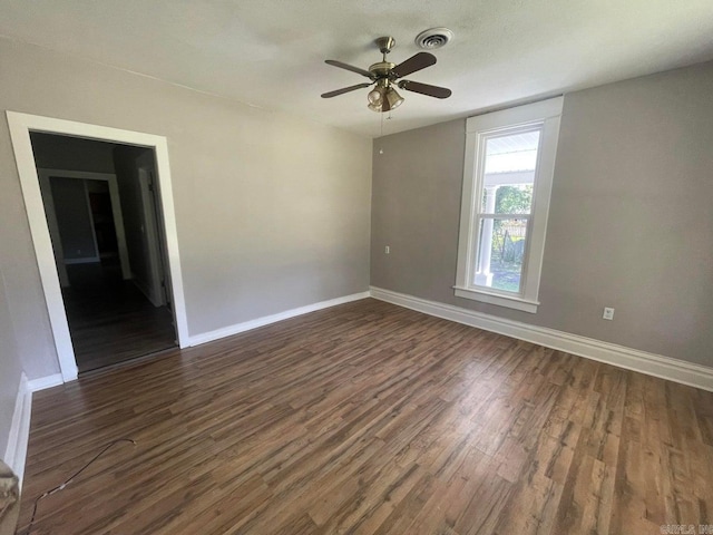 spare room featuring ceiling fan and dark hardwood / wood-style flooring