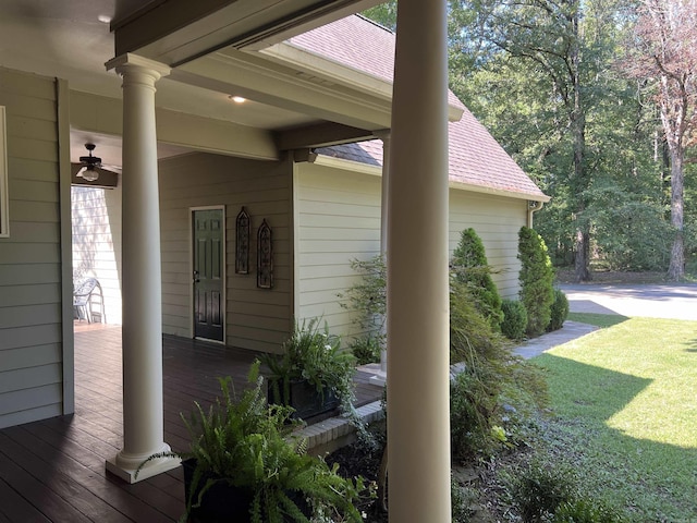 view of property exterior featuring a porch, roof with shingles, and a yard