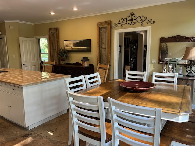 dining room with ornamental molding and recessed lighting