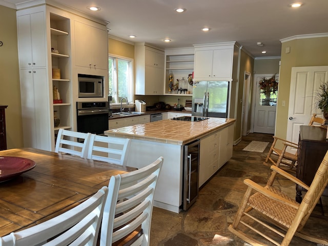 kitchen with wine cooler, appliances with stainless steel finishes, open shelves, and tile counters