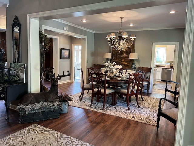 dining room with a notable chandelier, crown molding, and wood finished floors