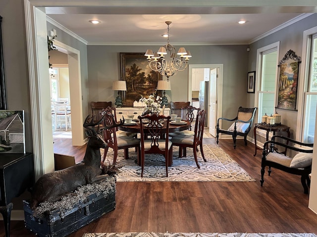 dining area with baseboards, ornamental molding, dark wood finished floors, and an inviting chandelier