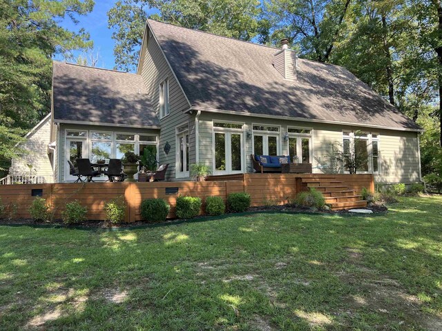 view of front of property with a wooden deck and a front yard