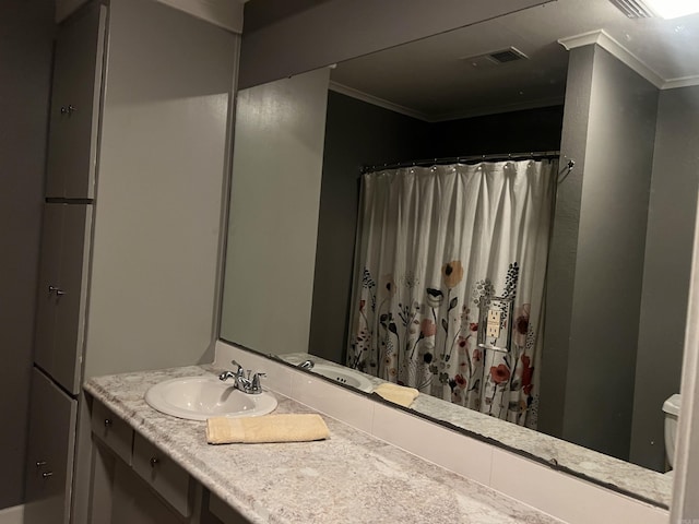 bathroom featuring curtained shower, toilet, vanity, visible vents, and crown molding