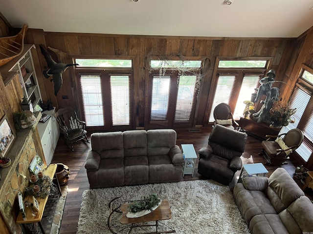 living room with wood walls and wood finished floors