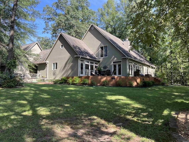 view of side of home with a lawn and a chimney