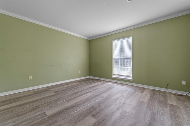 unfurnished room with wood-type flooring and ornamental molding