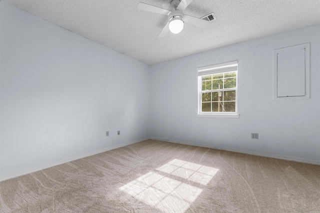 unfurnished room with a textured ceiling, ceiling fan, and light colored carpet