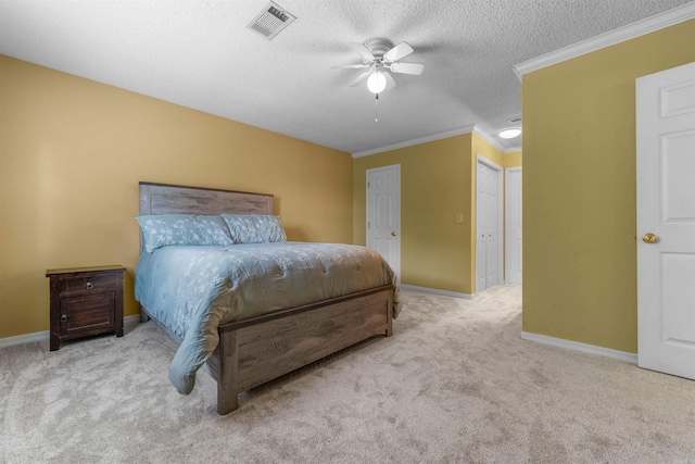 carpeted bedroom with ceiling fan, a textured ceiling, and ornamental molding