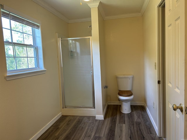 full bathroom with a stall shower, baseboards, toilet, wood finished floors, and crown molding