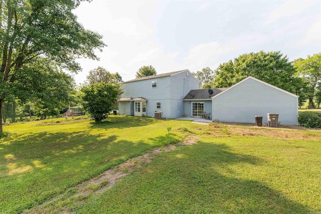 rear view of property with a patio area and a yard