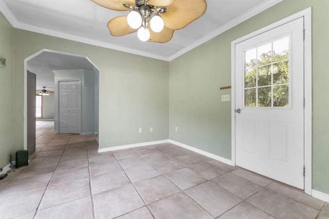 tiled spare room featuring ceiling fan and ornamental molding