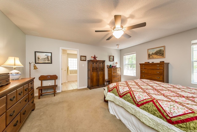 tiled bedroom featuring a textured ceiling, ceiling fan, and ensuite bathroom