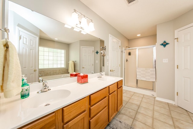 bathroom featuring tile patterned flooring, independent shower and bath, and vanity