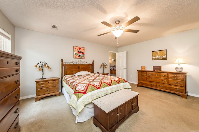 carpeted bedroom featuring a textured ceiling and ceiling fan