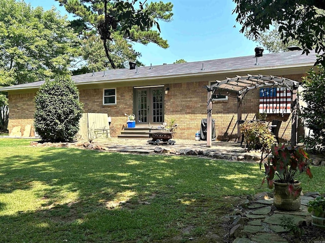 back of property with a patio area, french doors, and a lawn