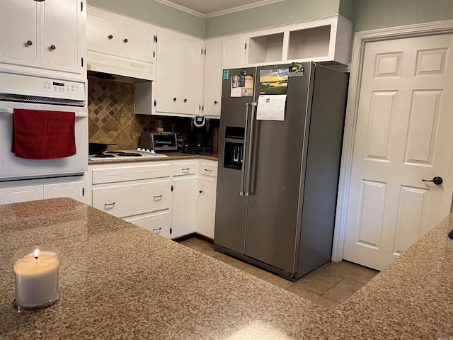 kitchen with tile patterned flooring, decorative backsplash, white cabinets, and white appliances