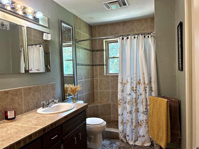 bathroom with toilet, walk in shower, and vanity