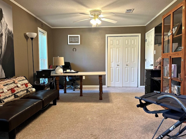 office space with ceiling fan, crown molding, a textured ceiling, and light carpet