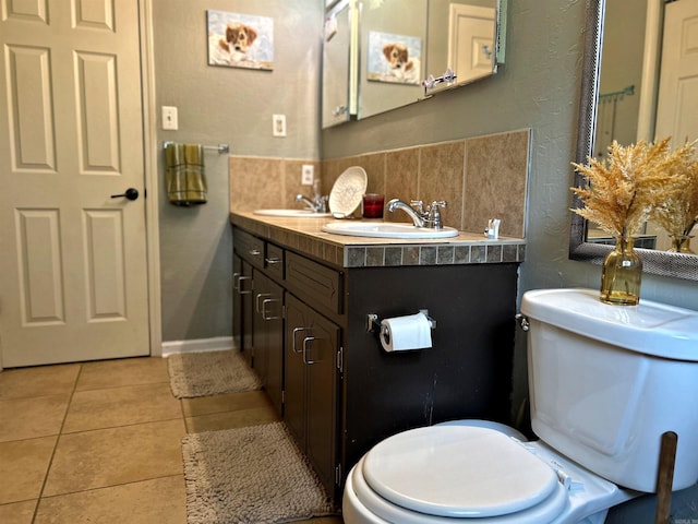 bathroom with backsplash, tile patterned flooring, toilet, and vanity