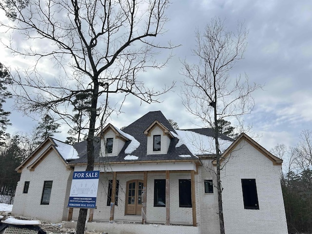 view of front of property with a porch and brick siding