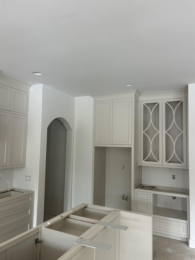 kitchen with glass insert cabinets and white cabinets