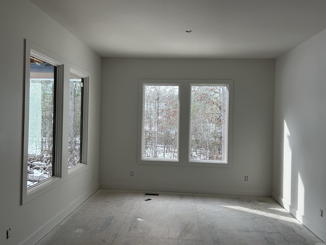 empty room with plenty of natural light and visible vents