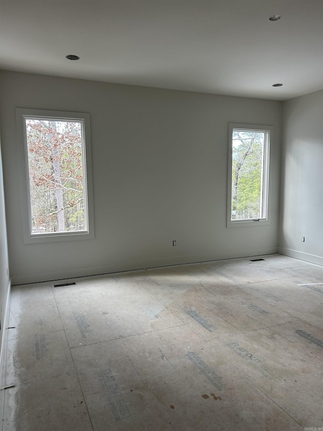 spare room featuring baseboards