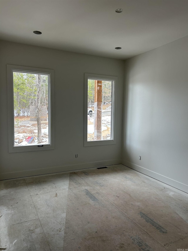 empty room featuring visible vents and baseboards