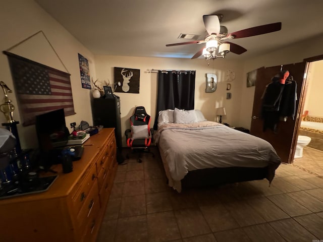 bedroom with tile patterned flooring, ceiling fan, and ensuite bathroom