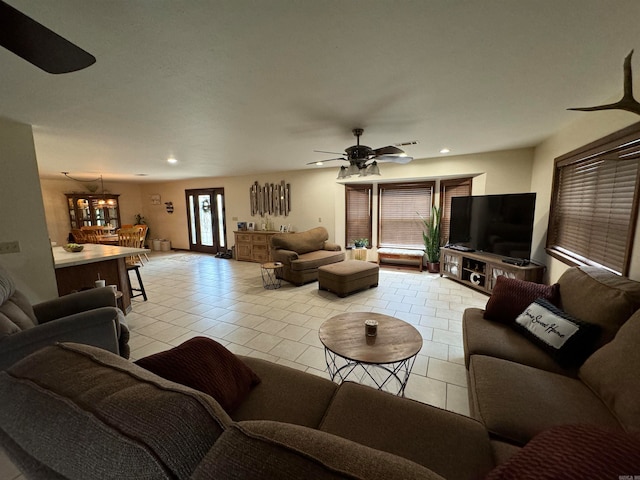 living room with ceiling fan and light tile patterned flooring