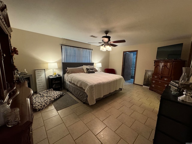 tiled bedroom with ceiling fan