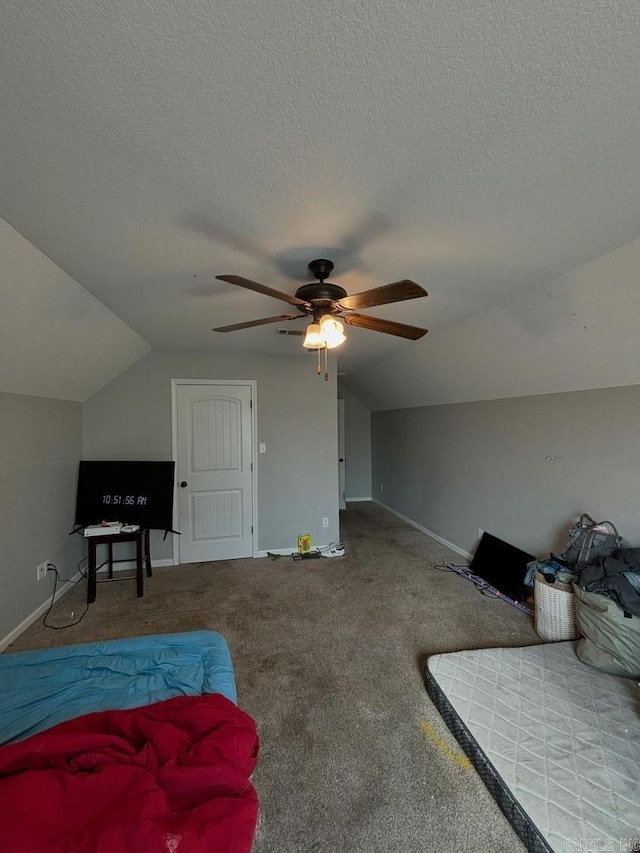 carpeted bedroom featuring ceiling fan, lofted ceiling, and a textured ceiling