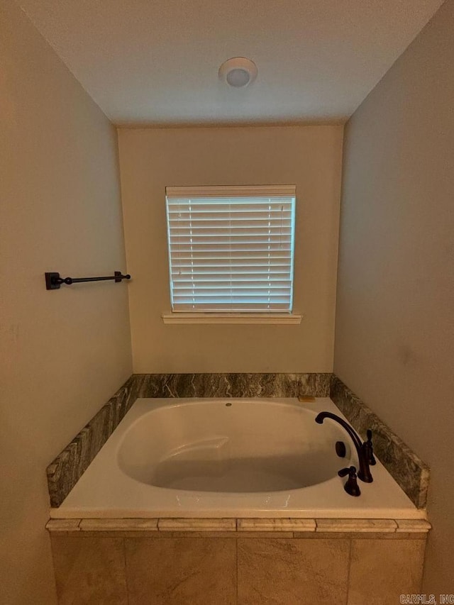 bathroom with a relaxing tiled tub