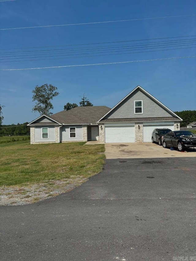 single story home featuring a garage and a front yard