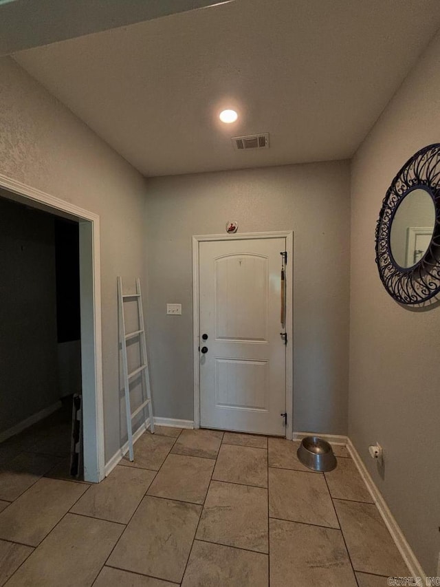 foyer entrance with light tile patterned flooring