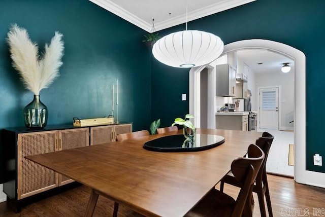 dining area featuring crown molding and hardwood / wood-style floors