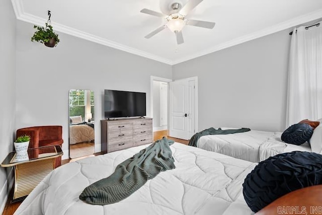 bedroom featuring hardwood / wood-style flooring, crown molding, and ceiling fan