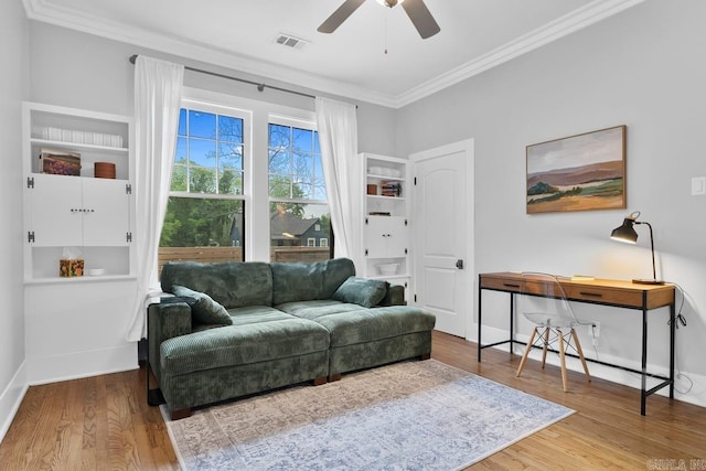 interior space with ceiling fan, hardwood / wood-style floors, and crown molding