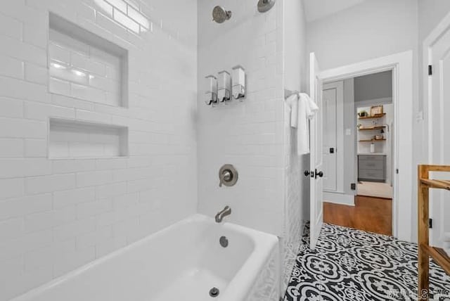 bathroom featuring tiled shower / bath combo and hardwood / wood-style flooring