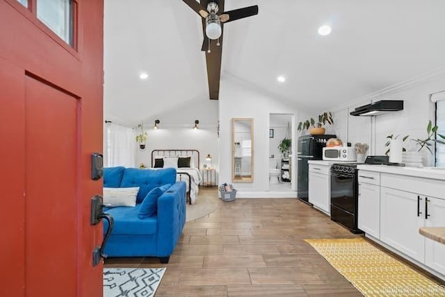 kitchen featuring light hardwood / wood-style flooring, beam ceiling, black appliances, white cabinets, and ceiling fan