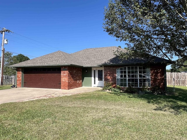 ranch-style house with driveway, a garage, fence, a front lawn, and brick siding